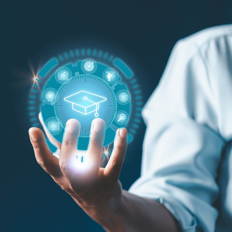Hand holding a glowing graduation cap hologram ringed with education icons