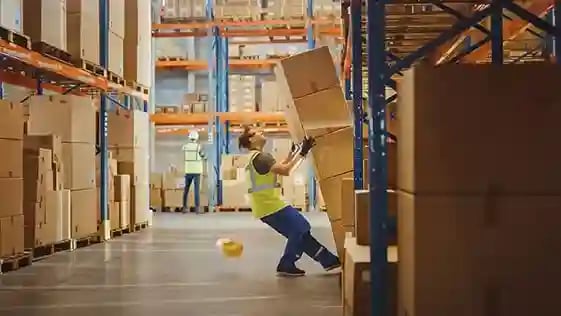 man moving boxes at work