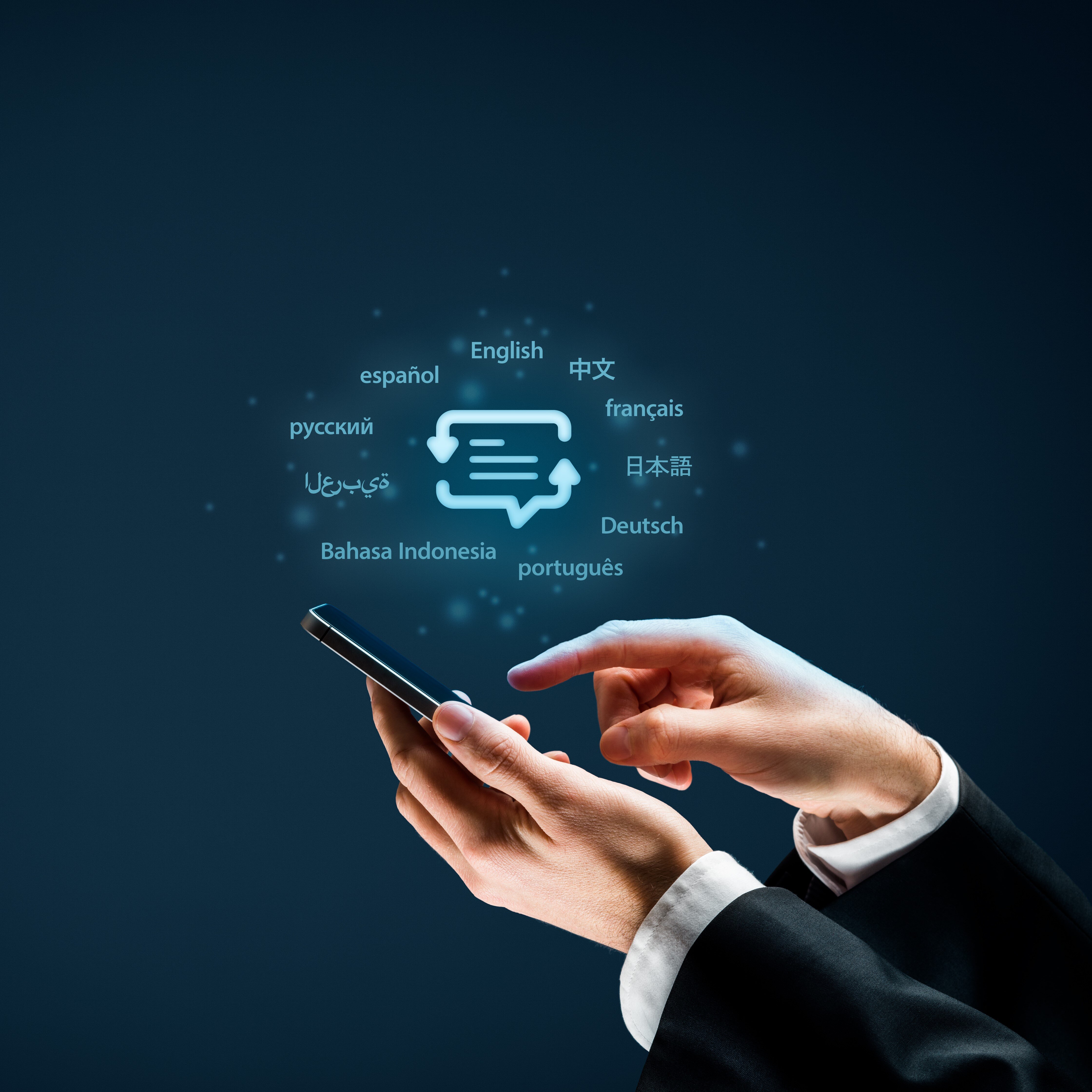 Hand holding a phone with a chat icon surrounded by language names