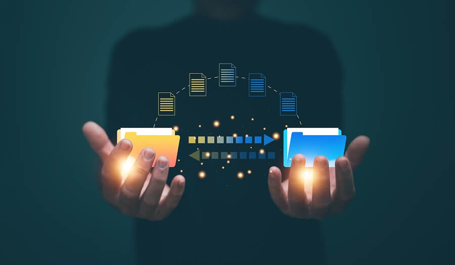 Person holding two folders with digital files transferring between them, representing translation memory reuse and data migration between vendors.