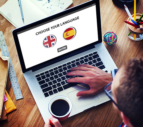 computer screen with two flags (english and spanish)
