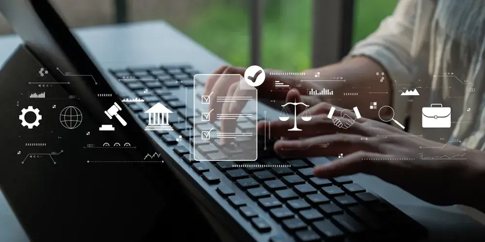 Hands typing on a laptop, overlaid with icons for a checklist, scales of justice and a government building