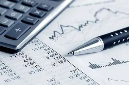 pen and calculator on finance document