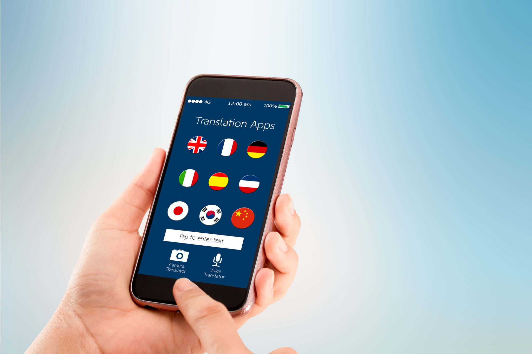 Hand holding a smartphone showing a translation app with a grid of language flags